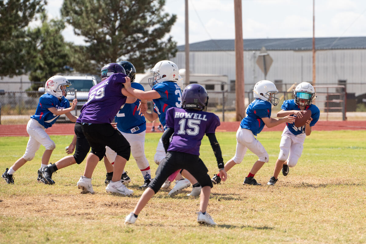 Tackle football ball carrier breaking through the line