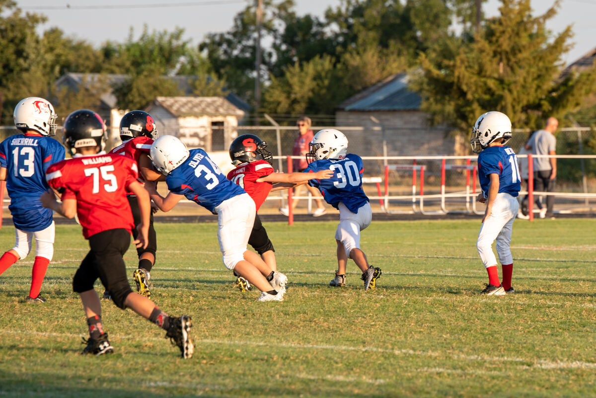 Tackle football players blocking at the line